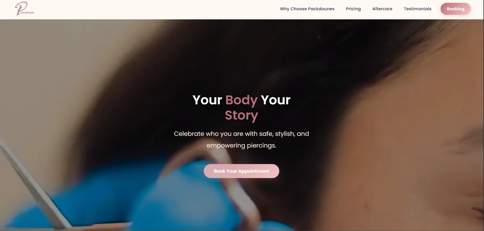 The top of the studio’s single page: a close-up of a piercing being performed, over the line “Your Body Your Story” and a booking button, with the navigation naming pricing, aftercare and testimonials.